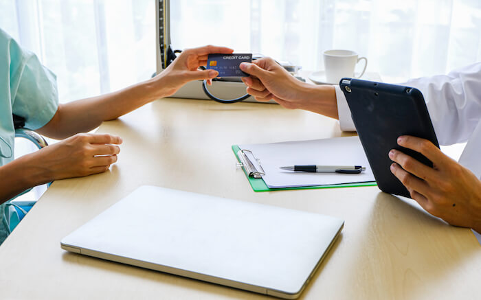 Woman paying medical bill with a credit card